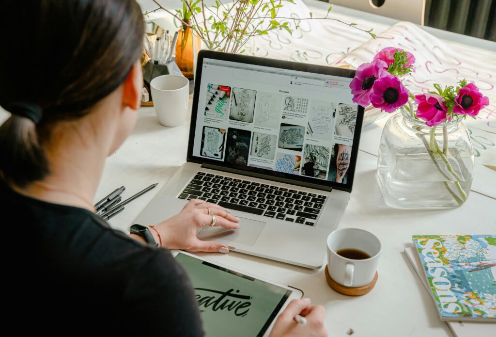 Lady working on a computer working on her creative website.